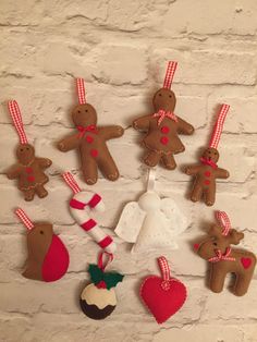 a group of gingerbread men and women hanging on a brick wall