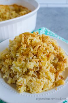 a white plate topped with rice next to a bowl