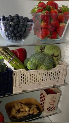 an open refrigerator filled with lots of fresh fruits and veggies in containers on shelves