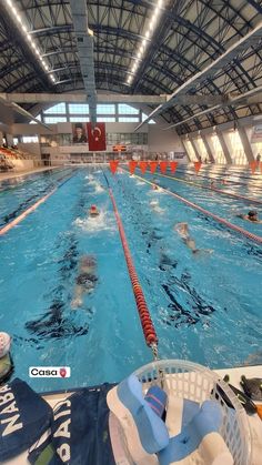 an indoor swimming pool with people in it