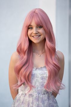 24" Pastel Pink Straight Wavy Wig With Bangs. Made with heat resistant synthetic fibers so the hair can be styled with a curling iron or flat iron under 250Fo degree. The cap is adjustable for easy wear and it mimics the look of a natural scalp. The Wig is open wefted with inner layer cap so you will feel light and comfortable when wearing it. Texture: Wavy Color: Pastel Pink Material: Heat resistant synthetic fiber  Length: 24 inches  Cap Size: Contains adjustable strap perfect for all sizes De Pastel Pink Wig, Silver Blonde Ombre, Pink Wig With Bangs, Wavy Wig With Bangs, Blonde Ombre Balayage, Celebrity Wigs, Wig Party, European Hair, Silver Blonde