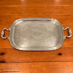 a silver tray sitting on top of a wooden table