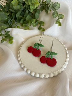 This pair of earrings is made with green and red polymer clay and silver colored hoops.  These would be perfect for anyone who loves cherries.  If you love these earrings snatch them up before someone else does.  If you have any questions or concerns feel free to contact owner and designer at HannahsJeweltique@gmail.com Visit my website at HannahsJeweltique.com Fun Red Round Jewelry, Playful Nickel-free Red Earrings, Trendy Red Nickel-free Hoop Earrings, Playful Red Nickel-free Jewelry, Cherry Earrings, Green And Red, If You Love, Kitchen Accessories, My Website