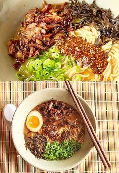 two bowls filled with noodles, meat and veggies next to chopsticks