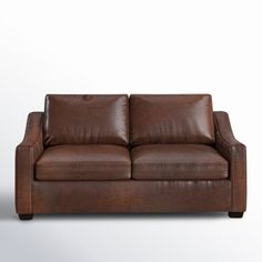 a brown leather couch against a white background