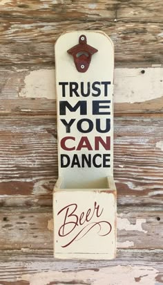 a sign that says trust me you can dance on the side of a wooden wall