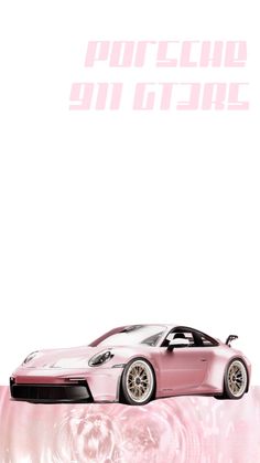 a pink car is sitting on top of a table