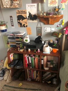 a cluttered room with many books and pictures on the wall