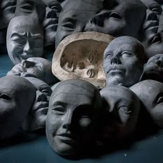 a group of clay heads sitting next to each other