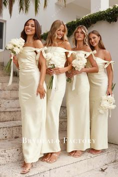 the bridesmaids are all wearing off - white gowns and holding bouquets