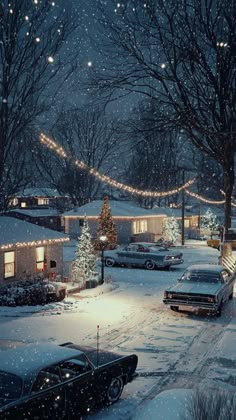 cars are parked on the street in front of houses covered with snow and christmas lights