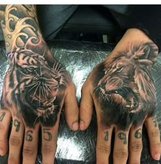 two hands that have tattoos on them and one has a tiger in the middle with numbers