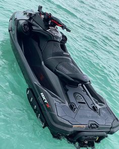 a jet ski is in the water with an attached motorboat on it's side