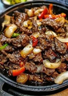 beef and onions stir fry in a skillet