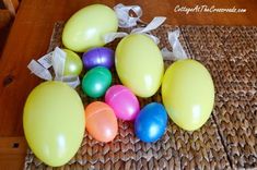 there are many different colored balloons on the matress that is laid out for us to play with