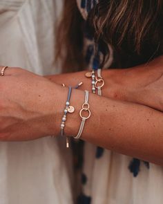 Introducing our new Sisters shareable hair tie & bracelet set. These are designed to celebrate the special connection between sisters! This beautiful set features dainty gold medal charms engraved with "Sis," along with delicate pearls, neutral colors, gold beads and interconnecting circles symbolizing the timeless bond you share. Whether worn as a hair tie or a bracelet, these accessories are fully adjustable to fit all sisters of every size and age. This darling set, perfect for gifting and sh Bracelets Sisters, Tie Bracelets, Hair Bracelet, Hair Tie Bracelet, Boutique Homes, Gold Medal, Wristbands, Hat Band, Hair Tie