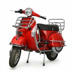 a red scooter is shown with the front light on and side bars down