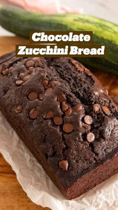 a loaf of chocolate zucchini bread sitting on top of a wooden cutting board