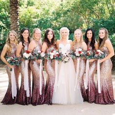 a group of women standing next to each other wearing dresses with sequins on them