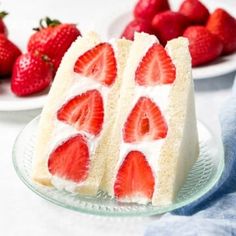 two slices of cake with strawberries on the side