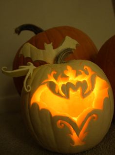 three carved pumpkins sitting next to each other