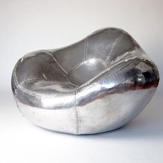 a silver bowl shaped like an oval object