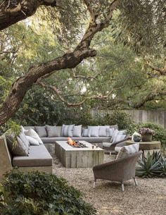 an outdoor living area with couches, chairs and tables in the middle of it