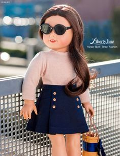 a doll wearing sunglasses and a skirt holding a purse