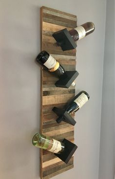 a wine rack made out of pallets with bottles on it