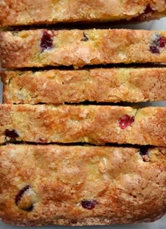 four pieces of fruit bread stacked on top of each other with cranberry toppings