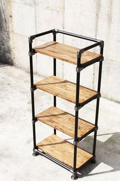 a wooden shelf sitting on top of a cement floor