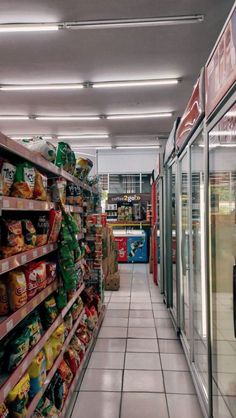 an empty grocery store aisle with food on the shelves