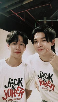 two young men standing next to each other wearing t - shirts with jack and joker on them