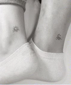 two small sun and moon tattoos on the ankle