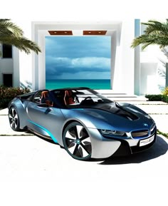 a futuristic car is parked in front of a house with palm trees and the ocean behind it