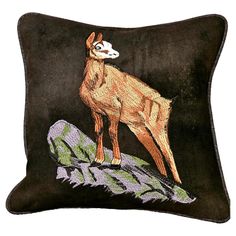 an embroidered pillow with a deer on it