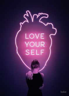 a woman standing in front of a neon sign with the words love your self on it