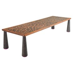 a long wooden table with metal legs and an animal print design on the top, against a white background