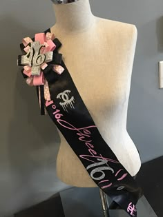 a mannequin wearing a black and pink ribbon with the word love on it