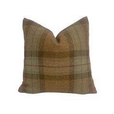 a brown plaid pillow on a white background