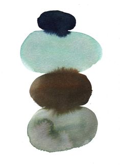 three rocks stacked on top of each other with watercolors in the bottom layer