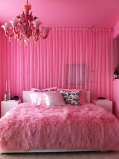 a bedroom with pink walls and fur rugs on the bed, chandelier hanging from the ceiling