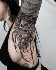 a woman with a spider tattoo on her arm