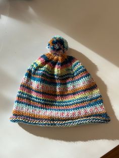 Colorful wool baby hat with pompom that brightens any coat! Playful Hats For Cold Weather, Playful Warm Hat For Playtime, Multicolor Hats For Playtime, One Size Fits Most, Playful Multicolor Hats For Cold Weather, Playful Multicolor Winter Beanie, Multicolor Playtime Hat, Cute Multicolor One-size Hats, Playful Multicolor Beanie Hat, Playful Multicolor Warm Beanie