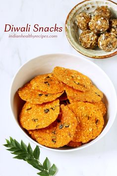 a white bowl filled with crackers next to a plate of cookies