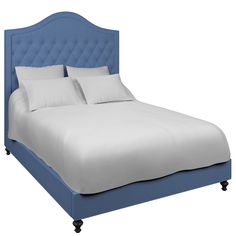 a bed with white sheets and blue headboard on it's side, in front of a white background