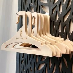 a bunch of wooden clothes hangers hanging on a wall