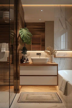 a bathroom with a sink, bathtub and large plant in the middle of it