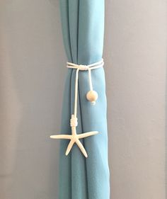 a curtain with starfish and seashells attached to it