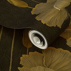 an artistic wallpaper with gold and black leaves on the bottom, along with a white circle in the center